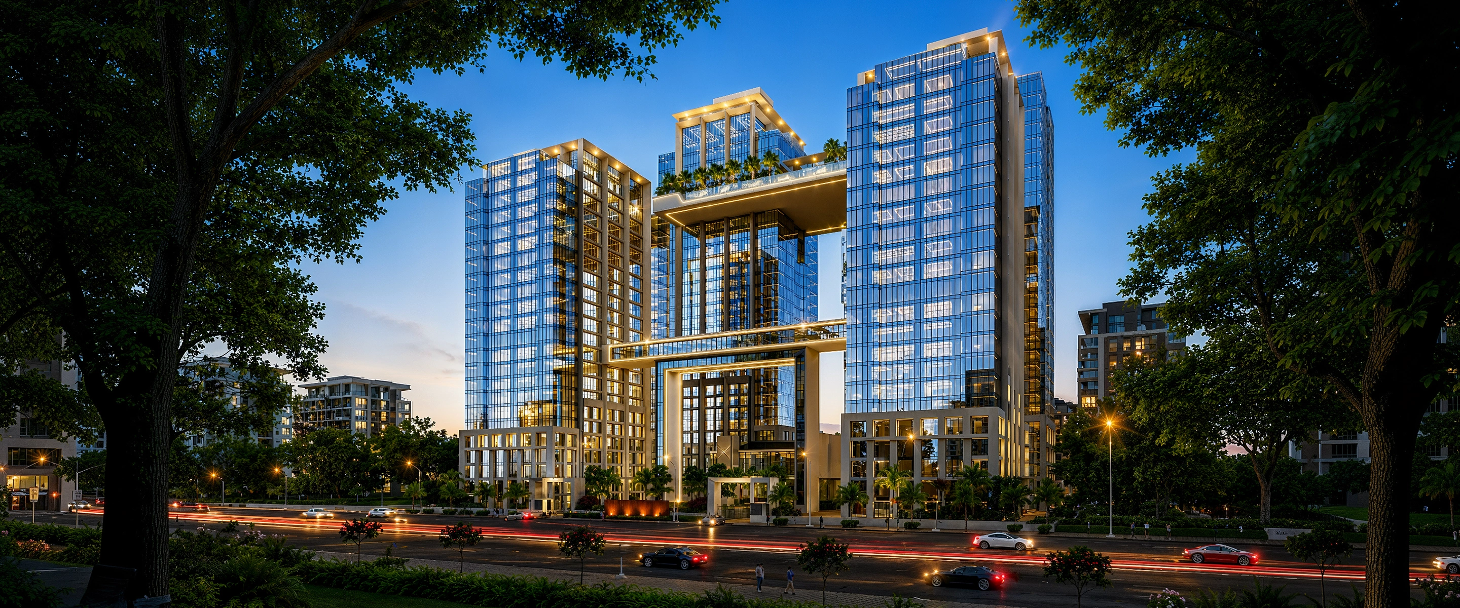 Twin glass towers linked by a sky bridge at dusk